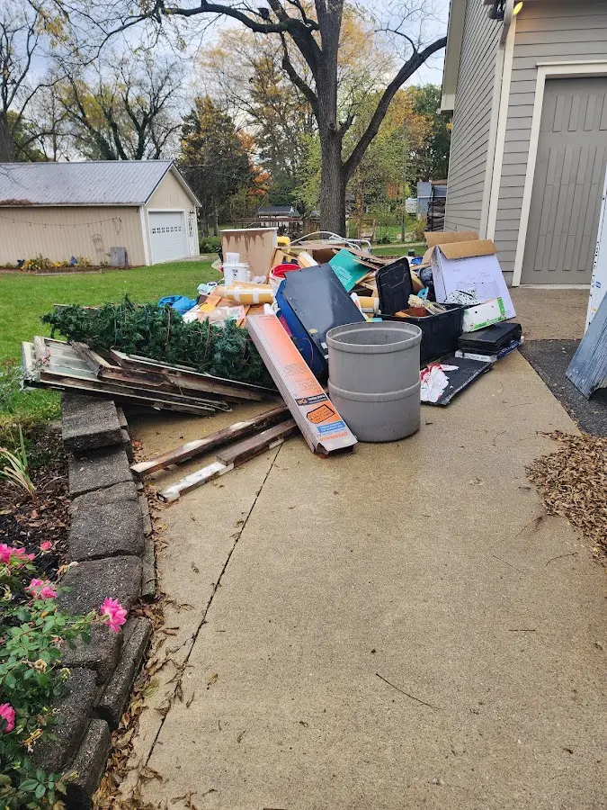 Dumpster being loaded with debris for 12 Yard Dumpster Rental in Mentor